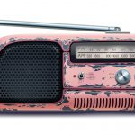 Vintage pink portable radio with antenna, knobs, and speaker grille, representing retro music devices.