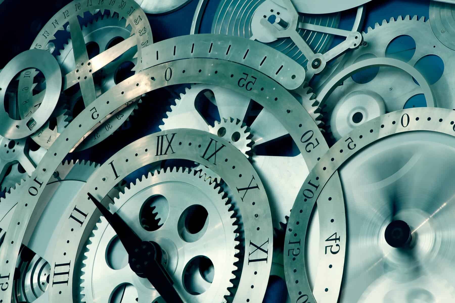 Vintage clock gears, intricate watch mechanism, timepiece engineering, precision gears, mechanical watch parts.