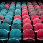 Colorful stadium seats in shades of blue, red, and black, highlighting virtual entertainment setting.